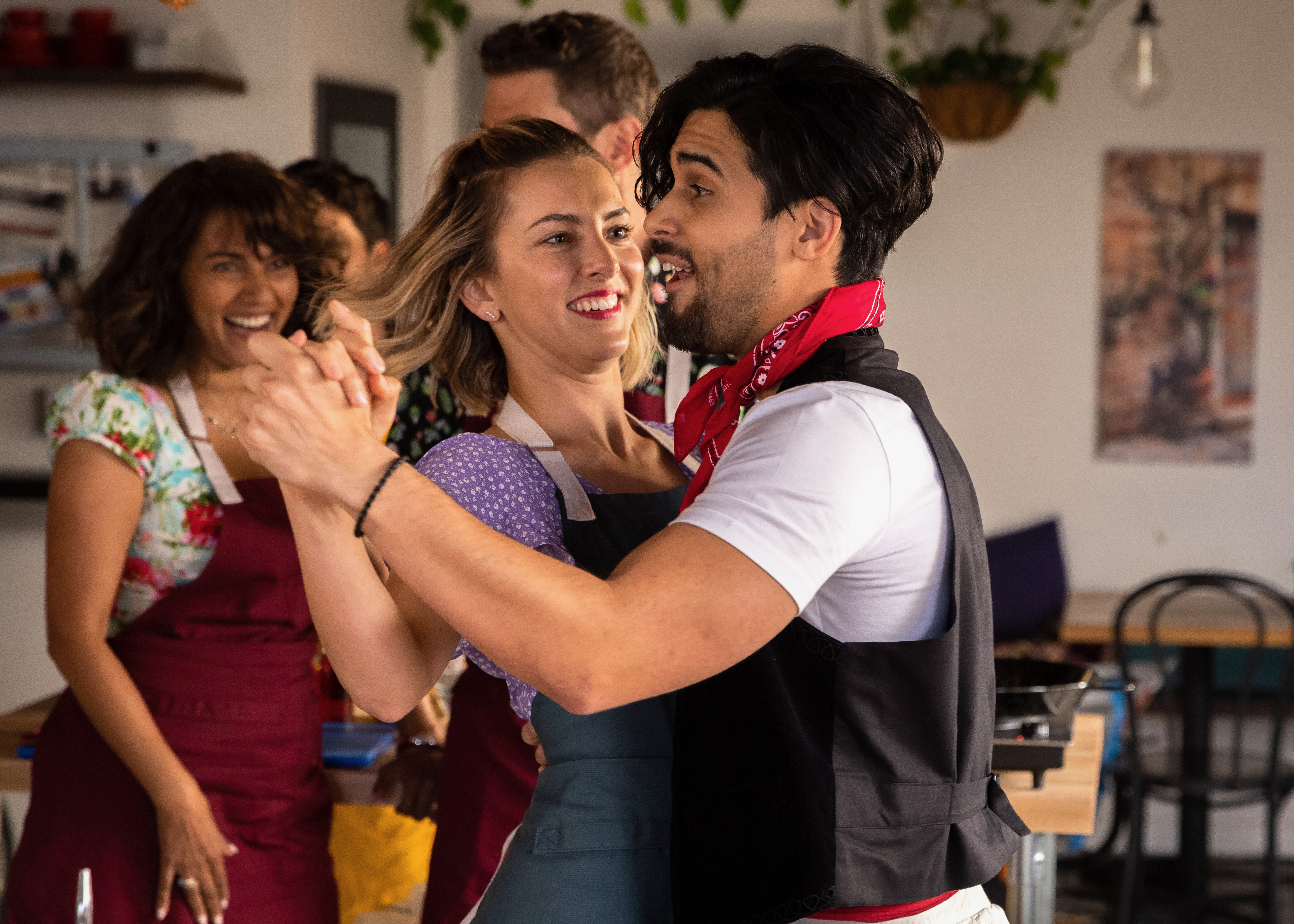 Leads dancing during a cooking class